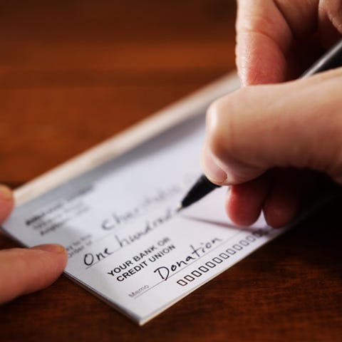 Writing a donation check to a charitable organizat