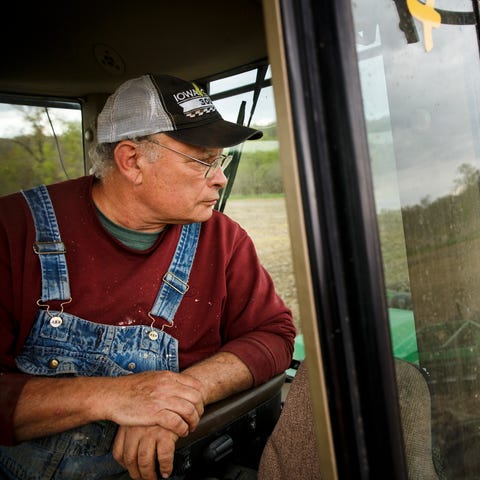 Jim Greif looks back over his tractor as he tills 