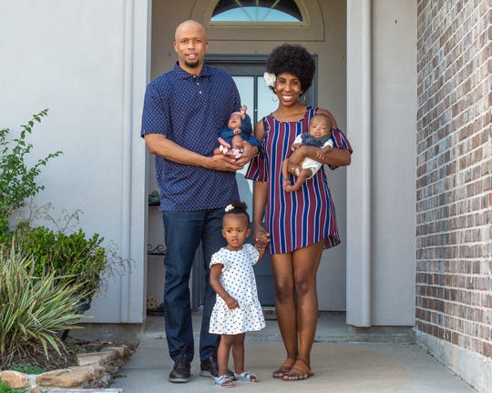 UL cornerbacks coach LaMar Morgan and his wife Jazen stand outside their home with twins Kalais and Krue and 2-year-old Kroix.