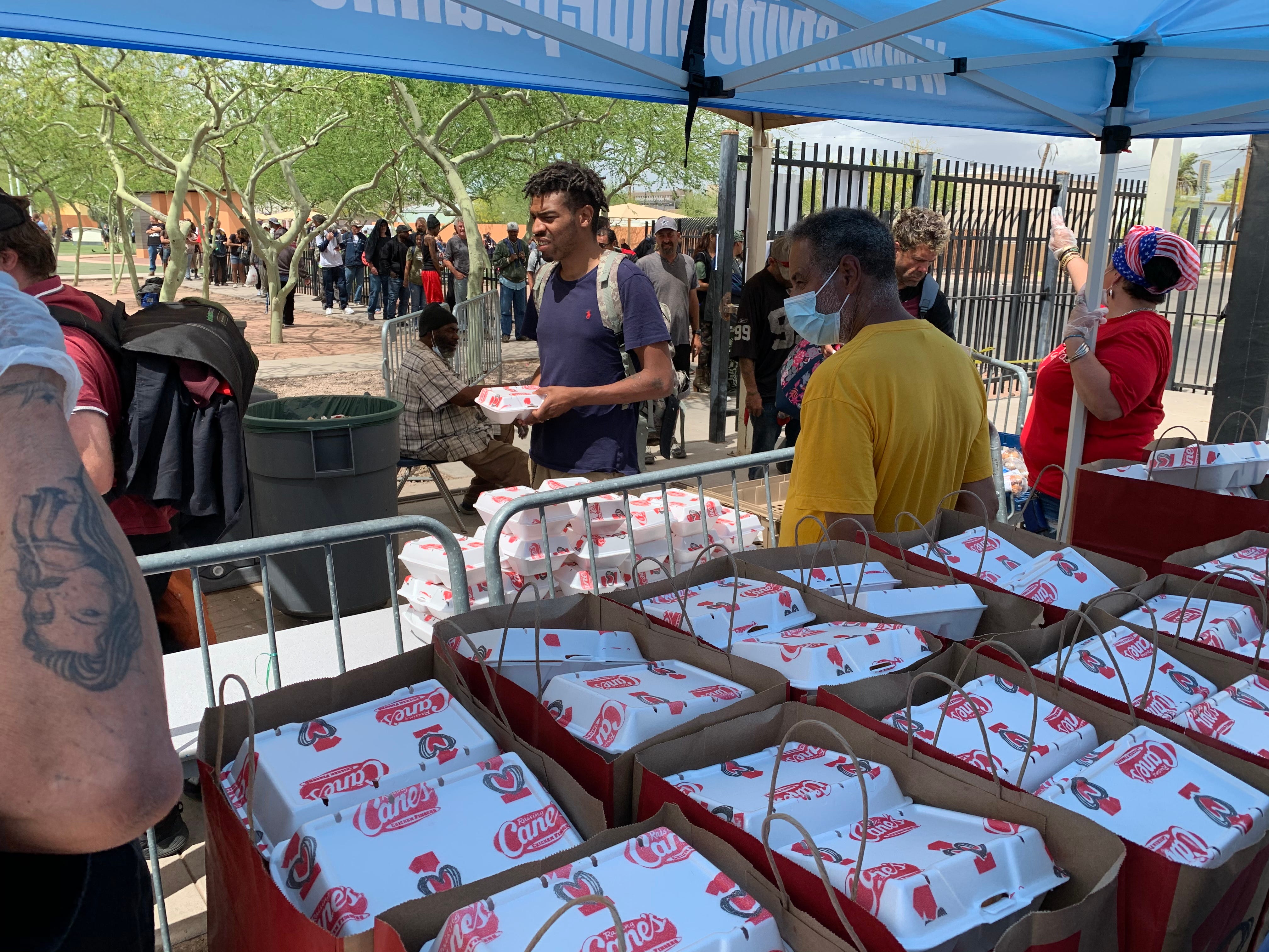 Meals purchased from local restaurants are handed out in May outside the five dining rooms at The Society of St. Vincent de Paul.