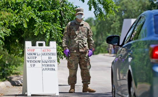 A member of the Texas National Guard works at a free coronavirus testing site at the McNease Convention Center on Wednesday, May 6, 2020.