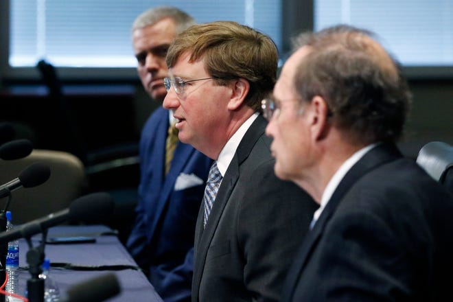 Gov. Tate Reeves, center, speaks of how he and House Speaker Philip Gunn, R-Clinton, left, and fellow Republican Lt. Gov. Delbert Hosemann, right, are now working on a deal about how to spend $1.2 billion in CARES Act funds, during Reeves' daily news conference, Thursday, May 7, 2020, in Jackson, Miss.