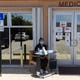 Adriana Contreras, a medical assistant at Treasure Coast Community Health in Fellsmere, sits outside the entrance of the clinic on Thursday, May 7, 2020, to screen patients for symptoms of COVID-19 before they enter the building.