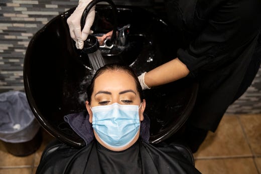 Angela Hernandez has her hair watched at Kosmo Salon on Friday, May 8, 2020. Barbershops and nail salons reopened on Friday, May 8, 2020 as part of Texas Gov. Greg Abbott's plan to reopen after coronavirus closures.