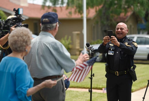 Corpus Christi police chief Mike Markle takes a photo of Bob Batterson during his surprise, drive-parade, Friday, May 8, 2020. Many elected officials attended the parade. 