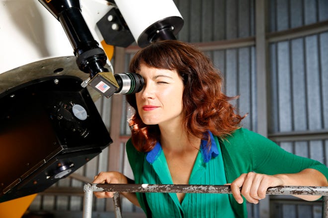 Lucianne Walkowicz looks at solar flares on the sun through a telescope at the Adler Planetarium's observatory in Chicago in 2015. The astronomer is suing the maker of American Girl dolls, alleging the Wisconsin company stole Walkowicz's likeness and name to create its space-loving doll.