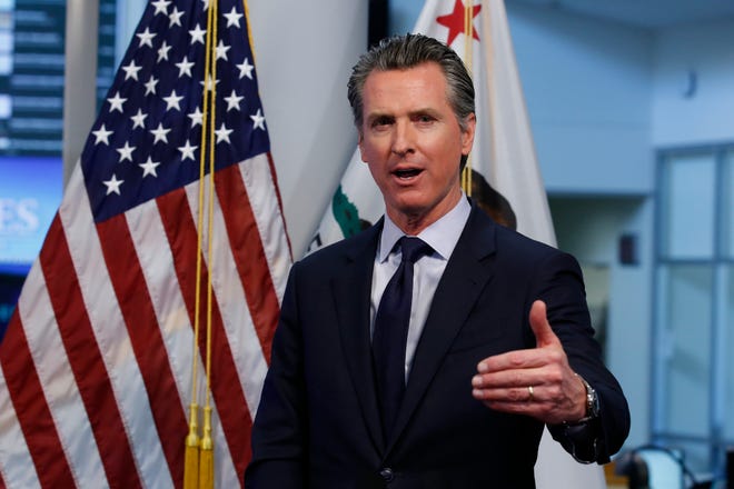 In this April 14, 2020, file photo, California Gov. Gavin Newsom gestures during a news conference at the Governor's Office of Emergency Services in Rancho Cordova, Calif.