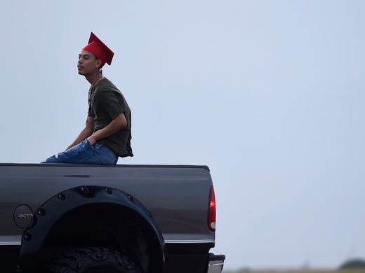 West Oso High School hosts a graduation parade for its seniors, Friday, May 8, 2020. The school had portraits of the seniors for families to drive by to support their graduates. 