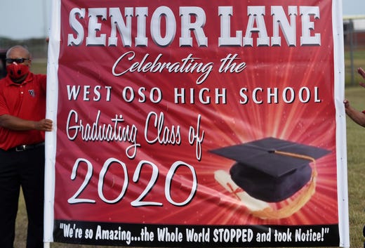 West Oso High School hosts a graduation parade for its seniors, Friday, May 8, 2020. The school had portraits of the seniors for families to drive by to support their graduates. 