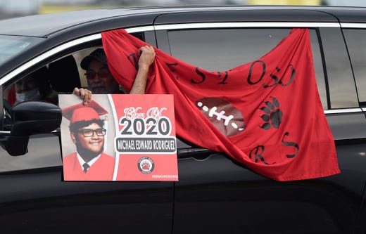 West Oso High School hosts a graduation parade for its seniors, Friday, May 8, 2020. The school had portraits of the seniors for families to drive by to support their graduates. 