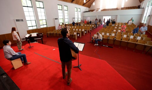 Pastor Bobby Contreras, center, leads his church in music churchgoers, using social distancing practices, return to in-person services at Alamo Heights Baptist Church, Sunday, May 10, 2020, in San Antonio. Texas' stay-at-home orders due to the COVID-19 pandemic have expired and Texas Gov. Greg Abbott has eased restrictions on many businesses, state parks, churches and places of worship.