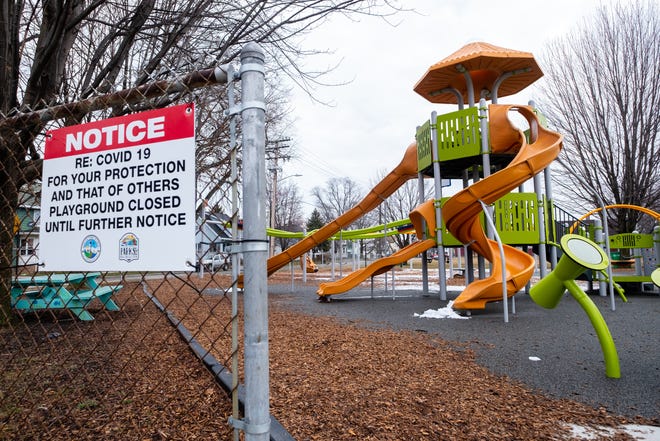 A sign telling visitors that the playground is closed hangs on the fence at Optimist Park Tuesday, March 24, 2020, in Port Huron. Parks have since reopened.