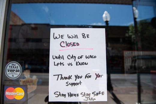 A hand-written signs alerts costumers that Jake’s Texas Tea House in Waco is closed indefinitely.