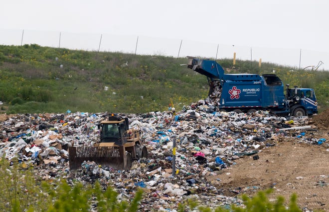Workers move garbage at Laubscher Meadows Landfill off St. Joseph Avenue Tuesday morning, May 12, 2020. Vanderburgh County Commissioners voted 3-0 to build a bridge to allow the landfill to transfer dirt beneath North St. Joseph Tuesday morning.