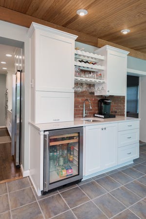 This kitchen renovations in Maryhill Estates features a small bar complete with seperate beverage fridge and coffee station.
