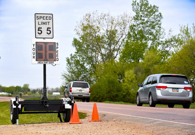 A speedometer from the sheriff's department is attached under a speed limit sign on County Highway 110 on Tuesday, May 12, in Harrisburg.