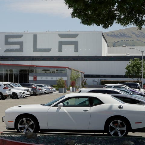 Vehicles are seen parked at the Tesla car plant Mo