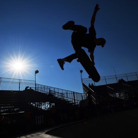 A skateboarder performs a frontside air during a p
