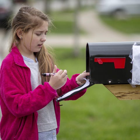 After taping her first tic-tac-toe win to the side