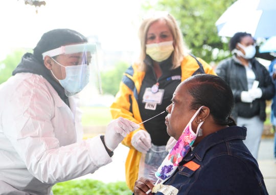 Patricia Jackson gets a nasal swab during a testing for Covid-19 outside the Louisville Urban League Wednesday morning. Norton Healthcare partnered with the Urban League to offer the appointment-only testing, either through walk-ups or drive-ins. May 13, 2020