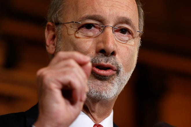 FILE - In this Dec. 29, 2015 file photo, Pennsylvania Gov. Tom Wolf speaks with members of the media at the state Capitol in Harrisburg, Pa. Wolf is attacking local elected officials making plans to reopen in defiance of his shutdown orders as cowards deserting the pandemic battlefield. Wolf threatened Monday, May 11, 2020 to block aid to rebellious counties in an escalating political fight over his administration's handling of the coronavirus. (AP Photo/Matt Rourke, File)