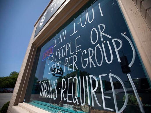 Rules for entering Cosmic Cowboy on South Congress Avenue in Austin are posted on the window.