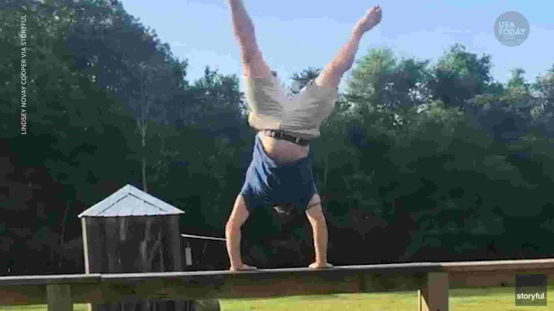 Dad does impressive gymnastics routine on fence