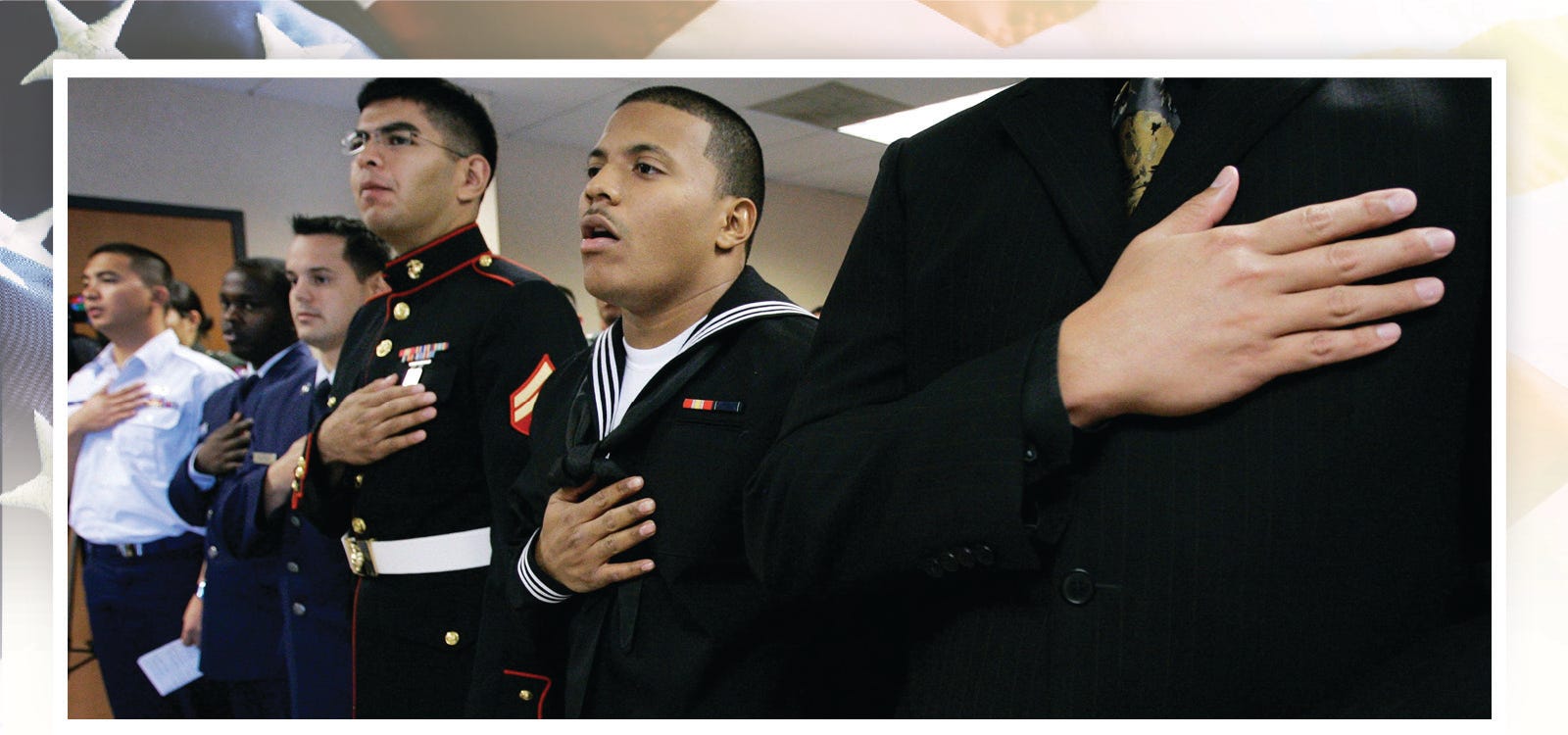 U.S. servicemen Honry Ong of the Philippines, left; Njoroge James of Kenya; Miguel Castano of Colombia; John Paul Reyes-Pina of Mexico; Jorge Gray of Panama; and Steven Cauthon, of South Korea,  right holding flag, take the oath of allegiance during a naturalization ceremony in Dallas, on Nov. 5, 2008. The six joined other U.S. service personnel becoming U.S. citizens.