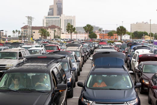 People wait in their car's at the American Bank Center for the Coastal Bend Food Bank and City of Corpus Christi's pop-up drive-thru food distribution on Friday, May 15, 2020 