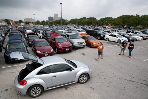 People wait in their car's at the American Bank Center for the Coastal Bend Food Bank and City of Corpus Christi's pop-up drive-thru food distribution on Friday, May 15, 2020 