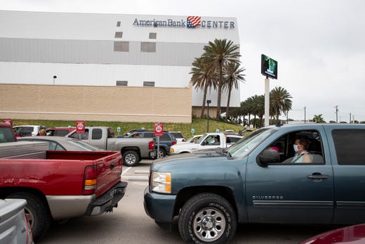 People wait in their car's at the American Bank Center for the Coastal Bend Food Bank and City of Corpus Christi's pop-up drive-thru food distribution Friday, May 15, 2020 