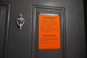 An eviction notice is served at an apartment.