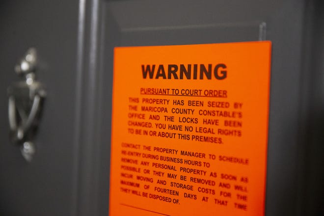 An eviction notice is served at an apartment in east Phoenix on May 15, 2020.