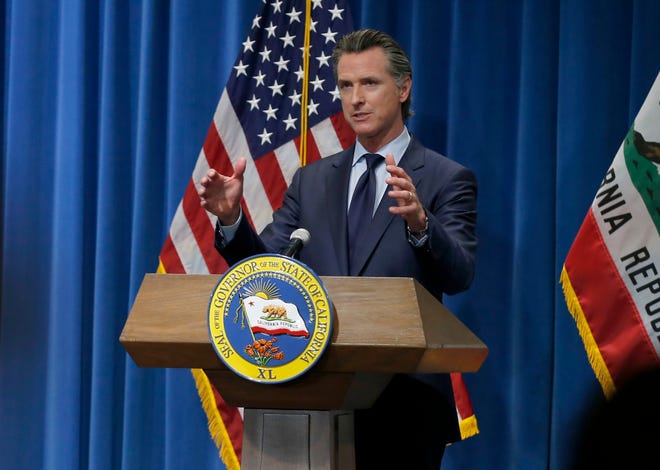 California Gov. Gavin Newsom discusses his revised 2020-2021 state budget during a news conference in Sacramento, Calif., Thursday, May 14, 2020.