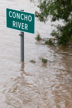 The Concho River floods over a road crossing after a heavy rain in September 2012.