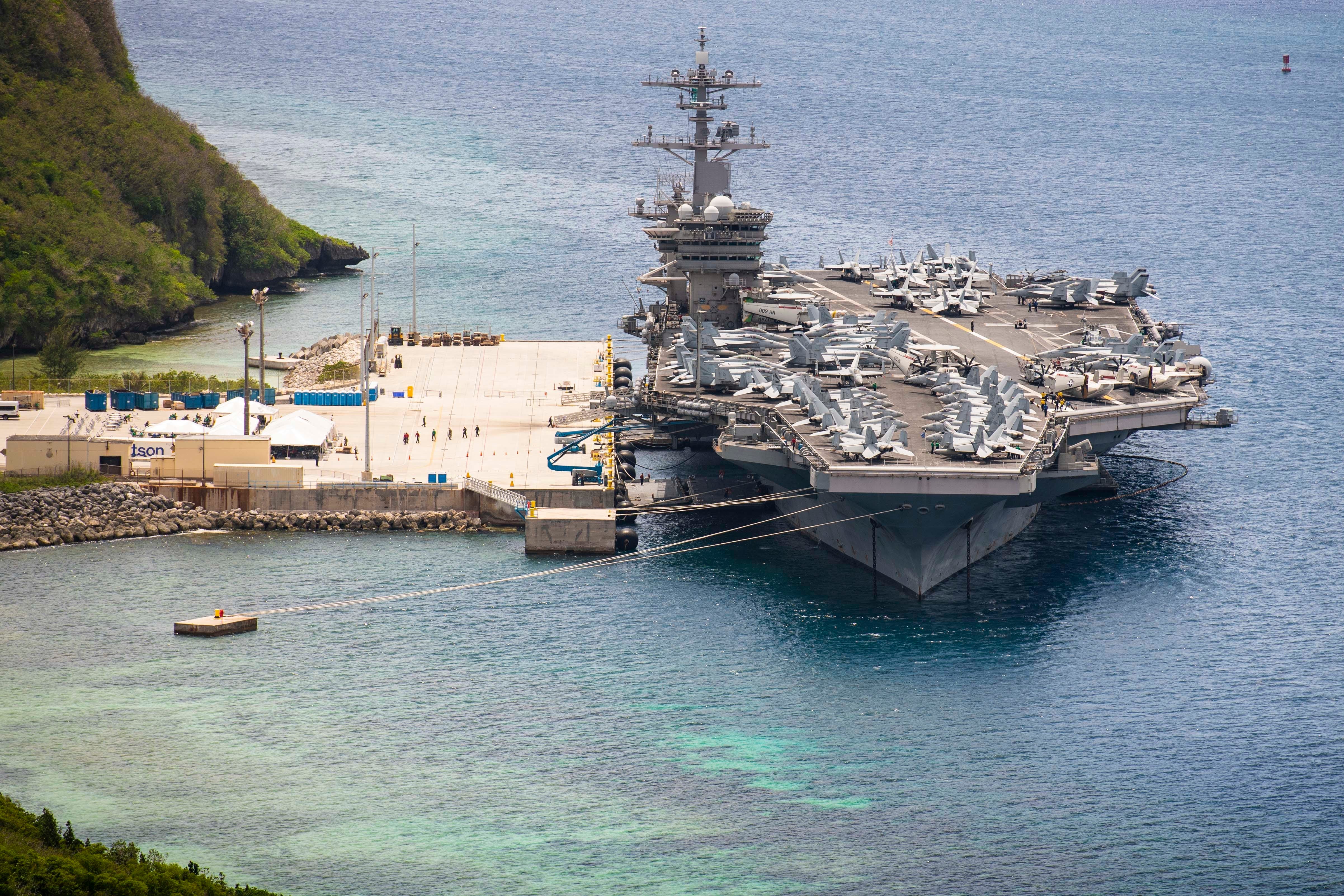 The aircraft carrier USS Theodore Roosevelt is moored at Naval Base Guam in May.