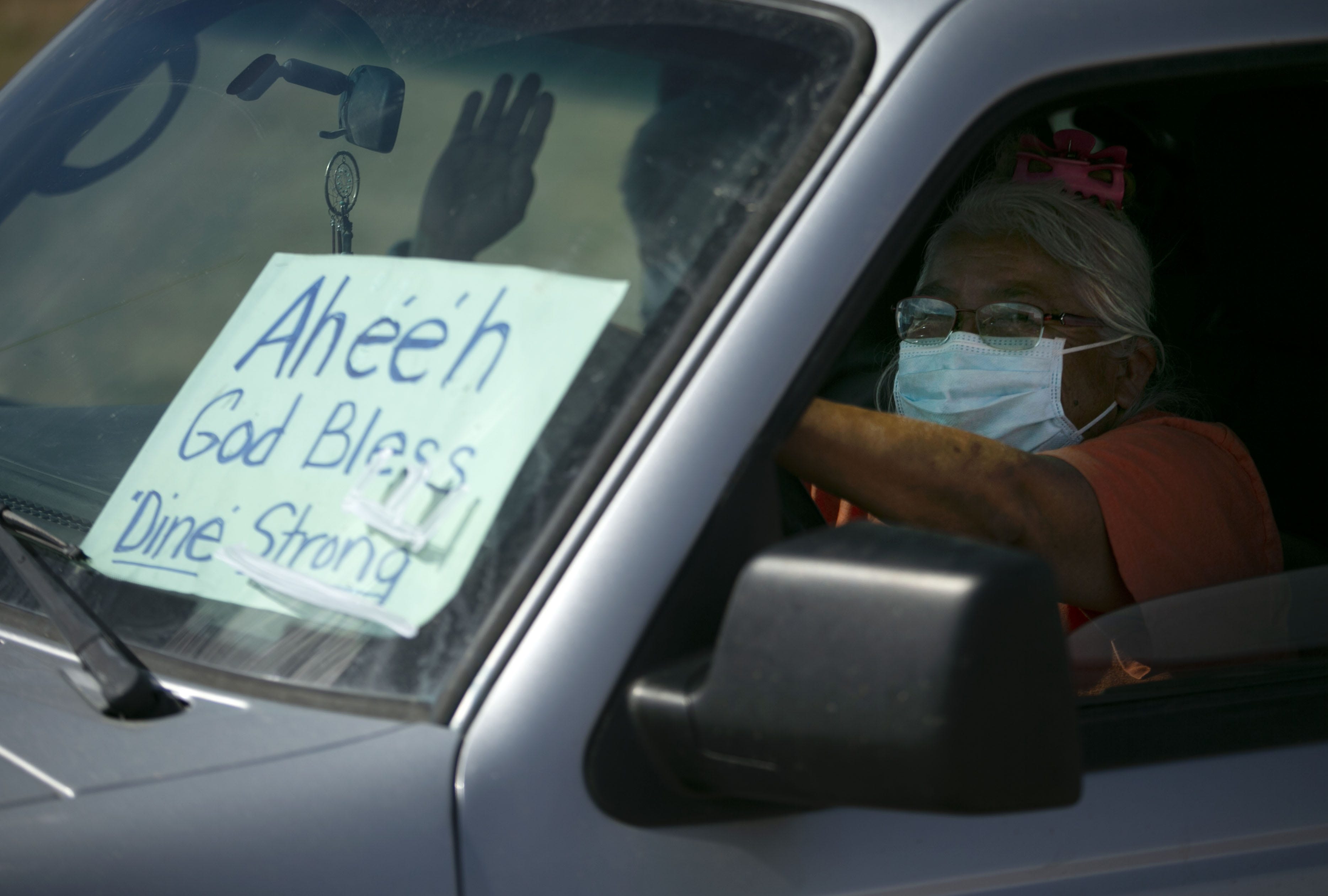 Terri Becenti waits in her vehicle to receive food before the start of a weekend-long curfew in Coyote Canyon, New Mexico, on the Navajo Nation on May 15, 2020.