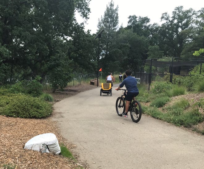 Cyclists enjoy the Sacramento River Trail in Redding. Local retailers report that bicycle sales have increased amid the coronavirus pandemic.