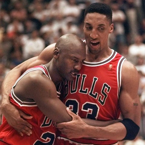 Michael Jordan collapses in the arms of teammate S