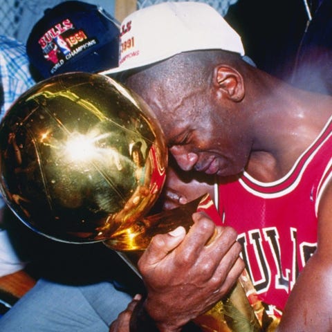 Michael Jordan hugs the NBA championship trophy af