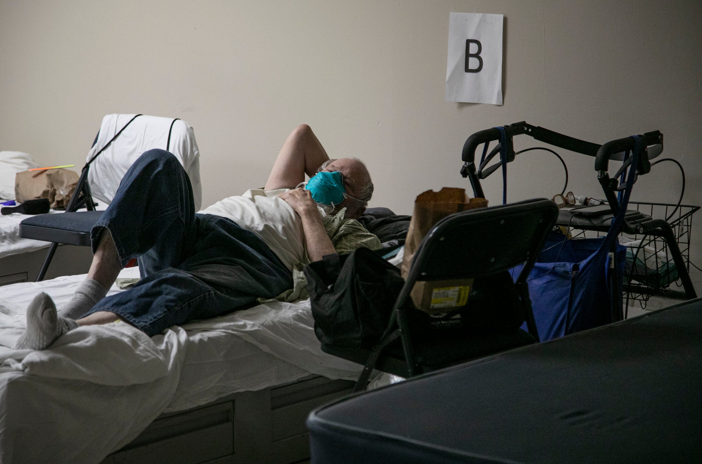 Sid Harris, 78, a homeless Army Veteran lays in his bed at The Salvation Army Harbor Lights facility in Detroit Friday, May 8, 2020. Harris tested positive for COVID-19 and is recovering at the Salvation Army Harbor Lights who is taking in COVID-19 positive and pending clients at their Detroit location.