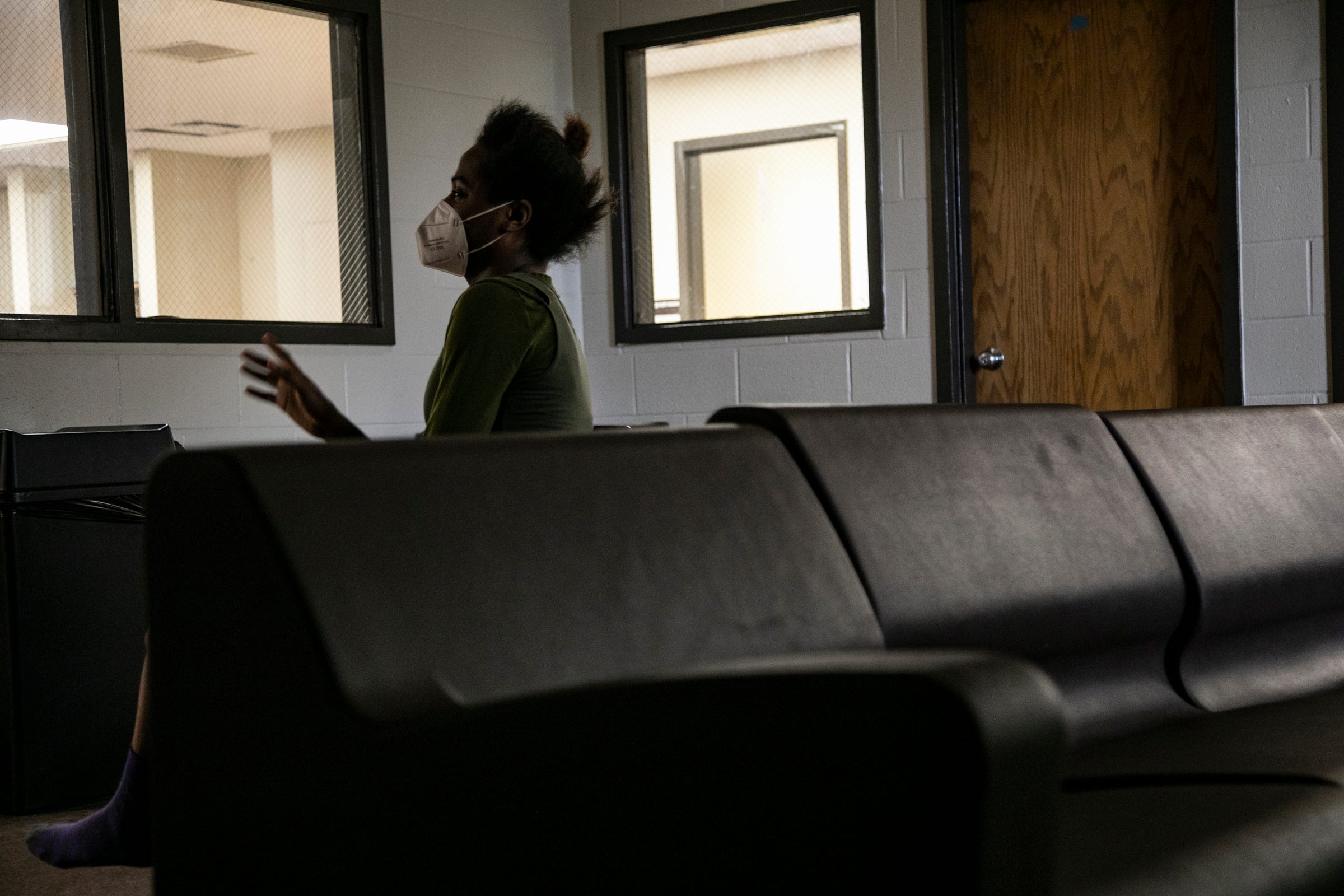 Jazmine Watts, 28, sits in the COVID-19 wing for women who have tested positive at The Salvation Army Harbor Light in Detroit Friday, May 8, 2020. The Salvation Army Harbor Light location is taking on and treating the homeless population to help mitigate the spread of COVID-19.