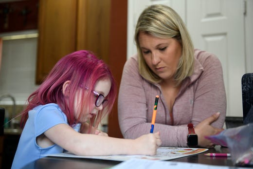 Four-year-old Keeley Mahan does her schoolwork, Wednesday, May 20, 2020, in Portland. Her mom, Jennifer, teaches her during the COVID-19 pandemic.