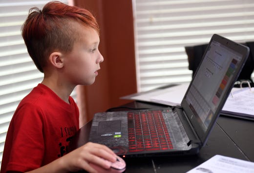 Seven-year-old Connor Mahan does his schoolwork, Wednesday, May 20, 2020, in Portland. His mom, Jennifer, teaches her during the COVID-19 pandemic. 