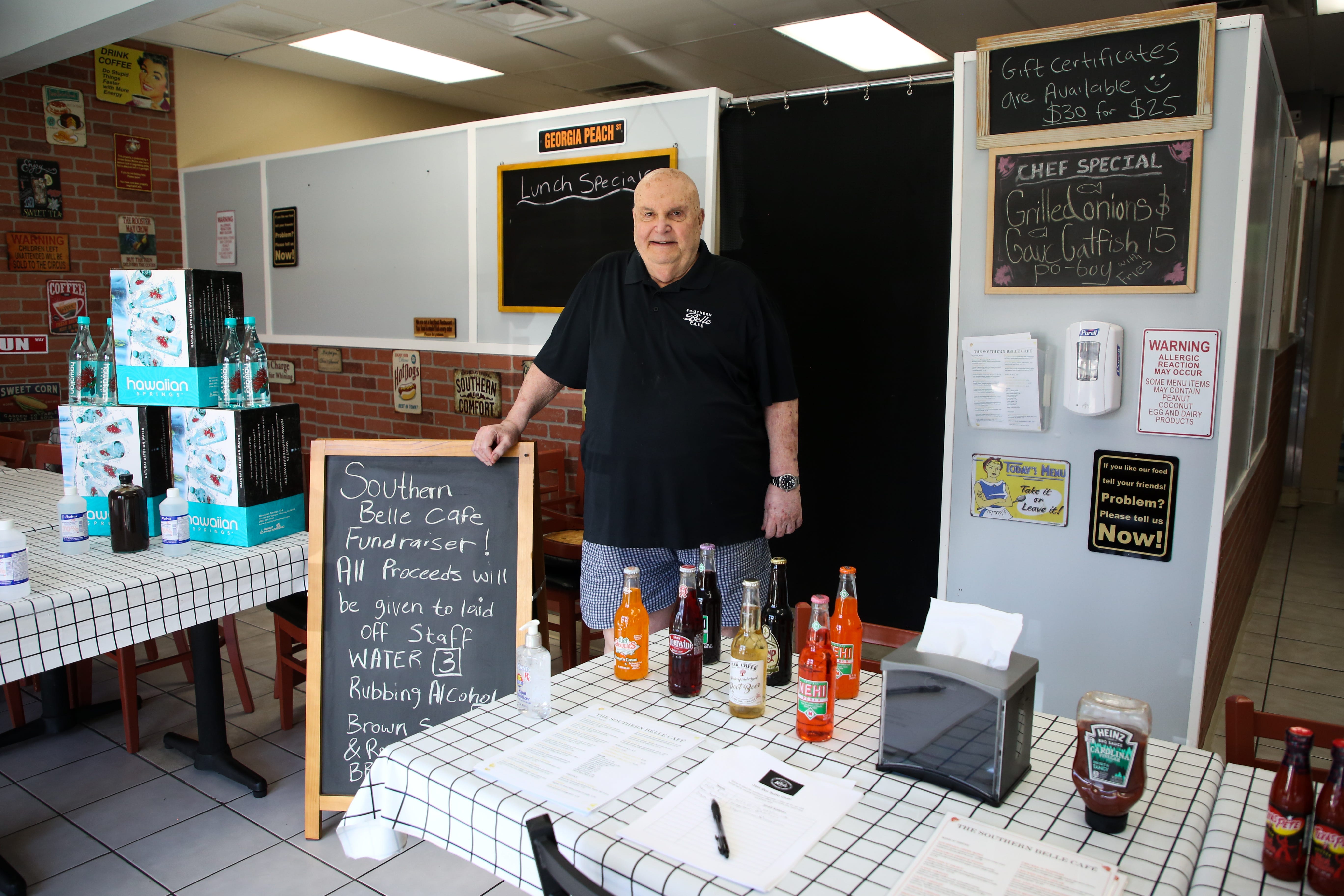 Southern Belle Cafe owner Bill Schneid stands in the entryway of his restaurant during the coronavirus pandemic on Tuesday, May 19, 2020 in Cathedral City, Calif.