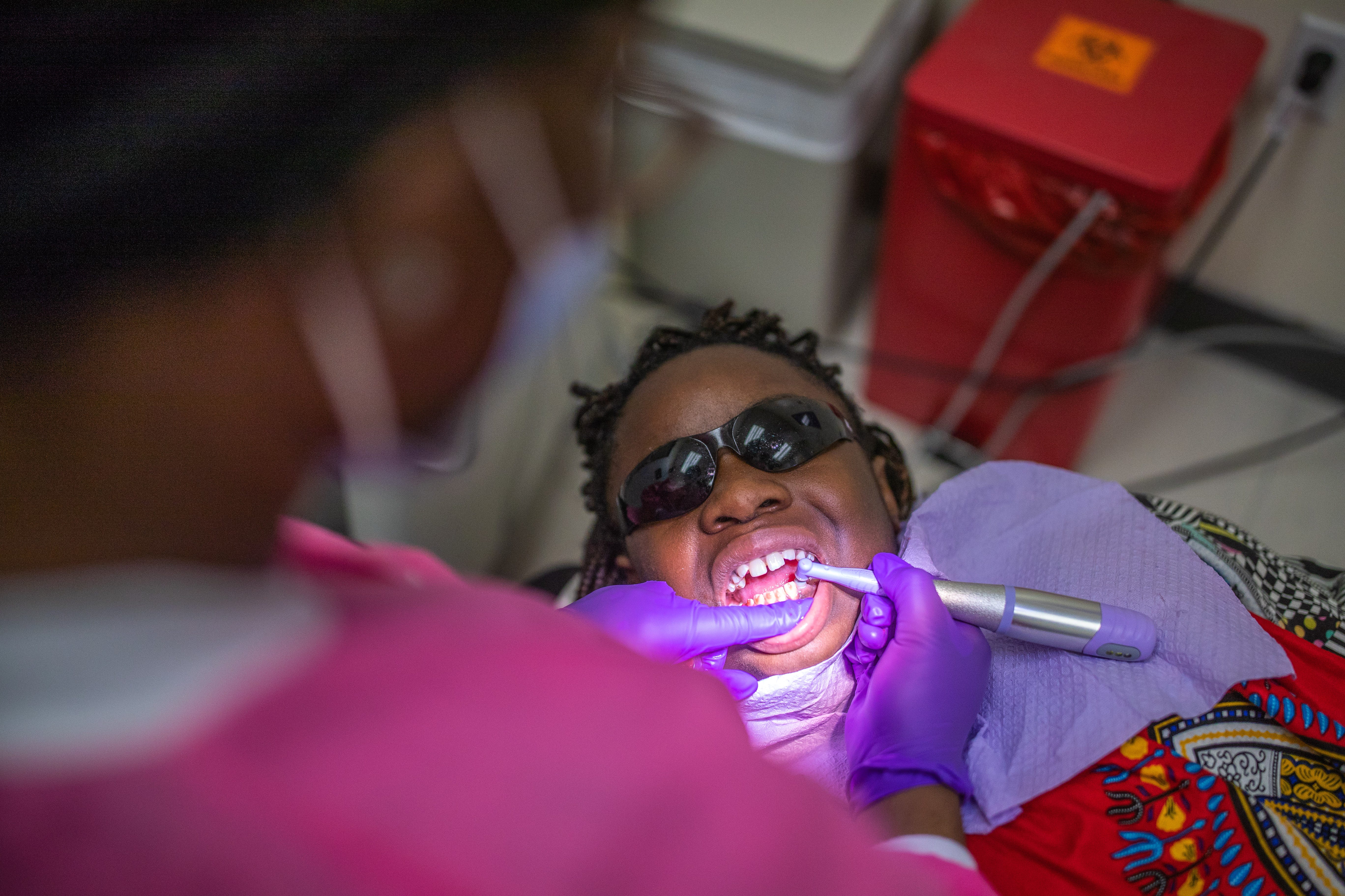 A dental hygienist cleans 11-year-old Deitra "DeeDee" Jackson’s teeth at Neighborhood Medical Center.