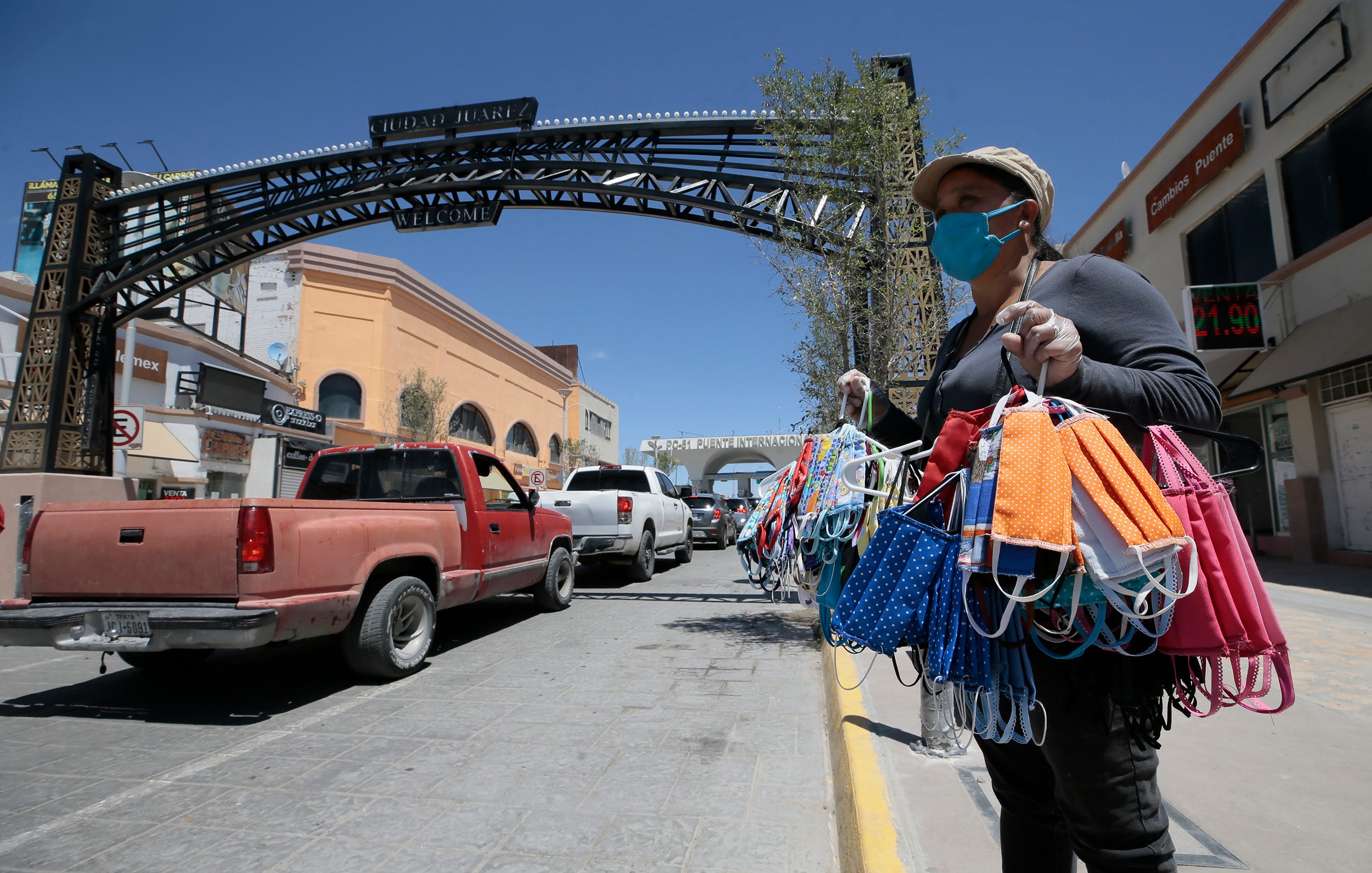 Elizabeth Martinez sells homemade coronavirus masks along Avenida Juárez to commuters crossing the Paso del Norte international bridge on May 20, 2020.