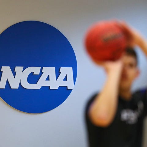 A NCAA logo is seen on the wall as Yeshiva players