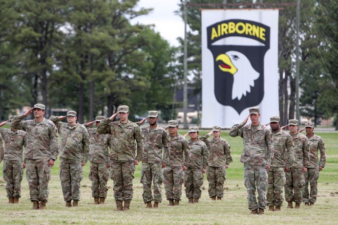Soldiers stand saluting before being allowed to rest  and their families to greet them across the field during a welcome home ceremony for soldiers from the 531st Hospital Center that had been deployed to New York to help at the Division Parade Field in Fort Campbell, KY., on Thursday, May 21, 2020. 