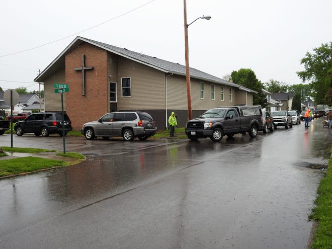 A long line of vehicle stretched for several blocks from the Upper Room Assembly and Worship Center on food distribution day in this Tribune file photo. On this day, the church gave out more than 55,000 pounds of food to 400 families. A new building on a lot next to the church will serve as a food pantry and youth activity center.
